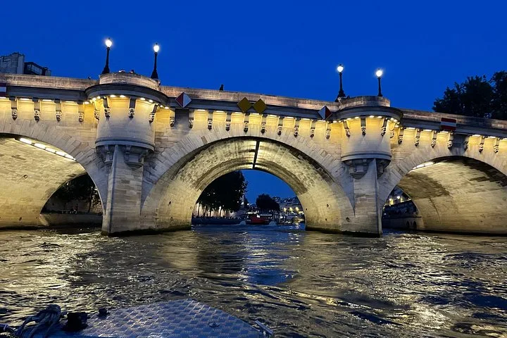 The lit arches of the Pont Neuf after dark